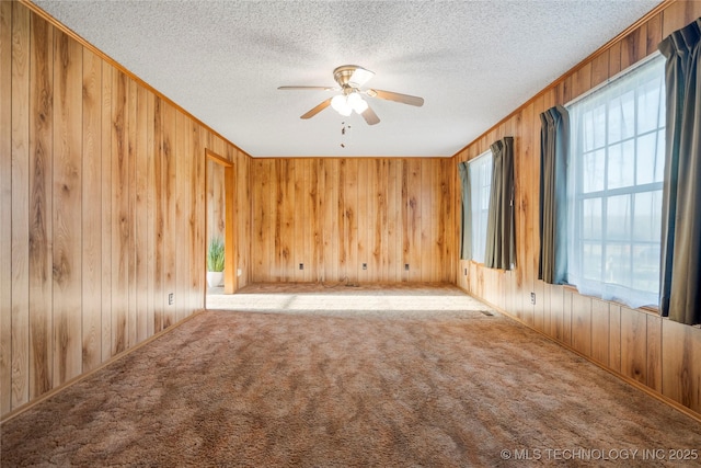 14531 S 107th W Ave, Sapulpa, OK 74066 - empty room featuring a textured ceiling, wooden walls, a ceiling fan, and carpet floors