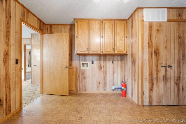 14531 S 107th W Ave, Sapulpa, OK 74066 - clothes washing area featuring visible vents, baseboards, a textured ceiling, cabinet space, and wood walls