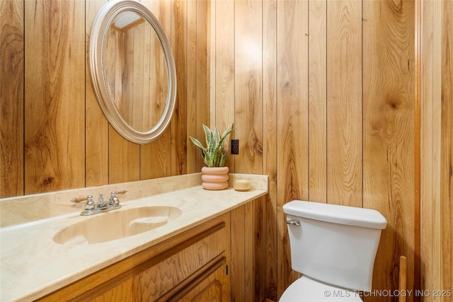 14531 S 107th W Ave, Sapulpa, OK 74066 - half bathroom featuring wooden walls, toilet, and vanity