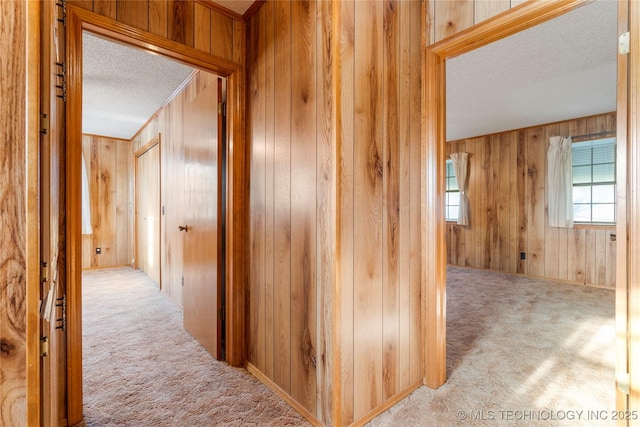 14531 S 107th W Ave, Sapulpa, OK 74066 - hallway with a textured ceiling, wood walls, and carpet flooring