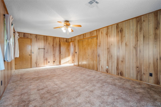 14531 S 107th W Ave, Sapulpa, OK 74066 - carpeted spare room with wooden walls, visible vents, a textured ceiling, and a ceiling fan