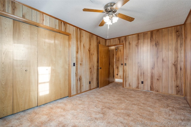 14531 S 107th W Ave, Sapulpa, OK 74066 - unfurnished bedroom featuring wooden walls, a ceiling fan, carpet, and a textured ceiling