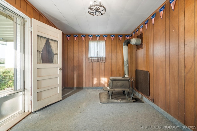 14531 S 107th W Ave, Sapulpa, OK 74066 - unfurnished living room featuring wood walls, a wood stove, and carpet