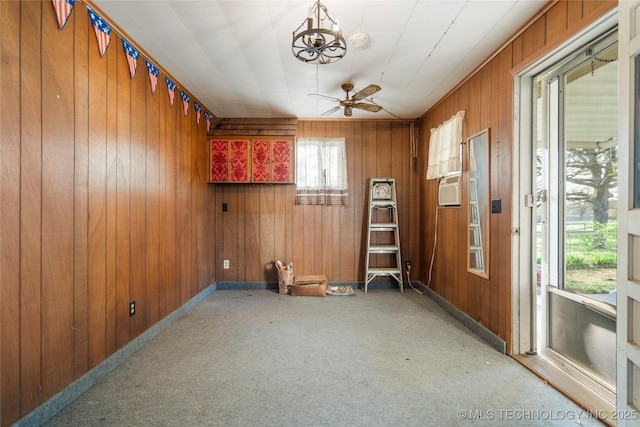 14531 S 107th W Ave, Sapulpa, OK 74066 - carpeted spare room featuring wood walls, cooling unit, baseboards, and ceiling fan with notable chandelier