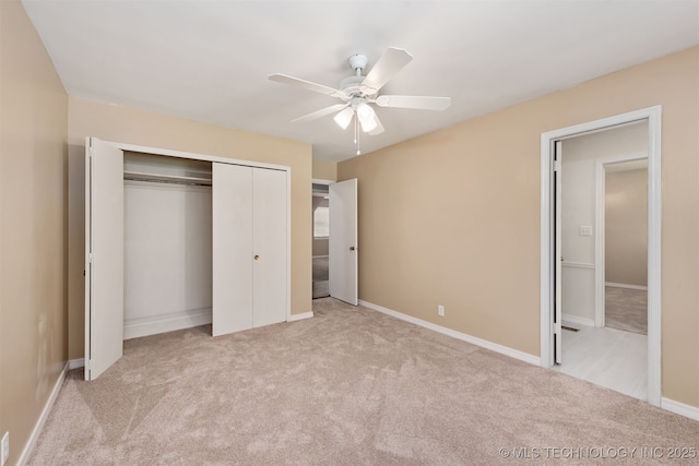 unfurnished bedroom featuring carpet floors, baseboards, a ceiling fan, and a closet