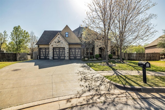 view of front of property with concrete driveway, stucco siding, stone siding, an attached garage, and fence