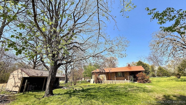 84936 S 4612th Rd, Stilwell, OK 74960 - view of green lawn with an outdoor structure and an outbuilding