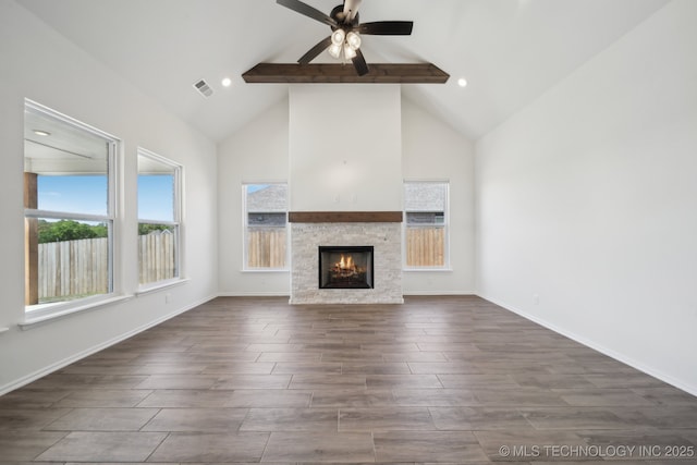 2916 S 8th St, Broken Arrow, OK 74012 - unfurnished living room with beamed ceiling, ceiling fan, high vaulted ceiling, a stone fireplace, and dark wood-style floors