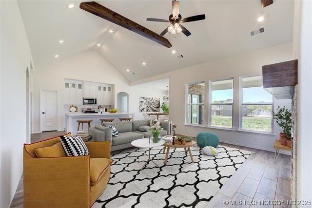 2916 S 8th St, Broken Arrow, OK 74012 - living room with a ceiling fan, beam ceiling, high vaulted ceiling, and arched walkways