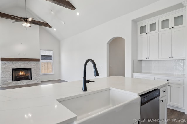 2916 S 8th St, Broken Arrow, OK 74012 - kitchen featuring stainless steel dishwasher, open floor plan, light stone countertops, a stone fireplace, and beam ceiling