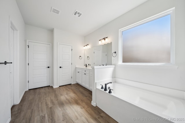 2916 S 8th St, Broken Arrow, OK 74012 - full bathroom with vanity, a bath, and wood finished floors