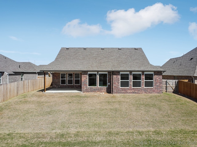2916 S 8th St, Broken Arrow, OK 74012 - back of property with brick siding, a patio, a fenced backyard, and a shingled roof