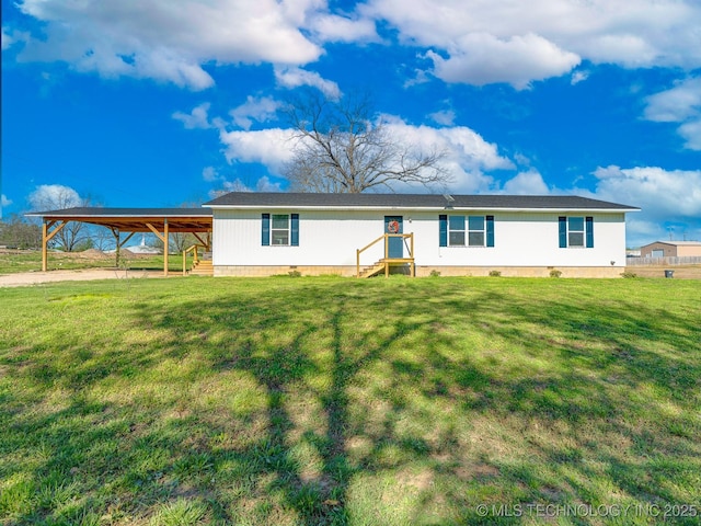 view of front of property with a carport, entry steps, and a front yard