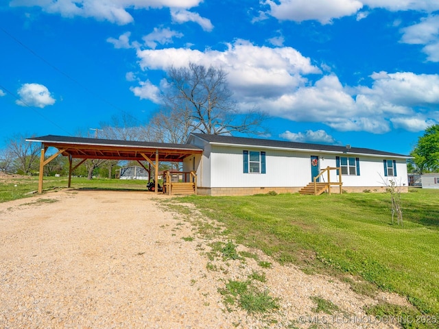 manufactured / mobile home with a carport, driveway, crawl space, and a front yard