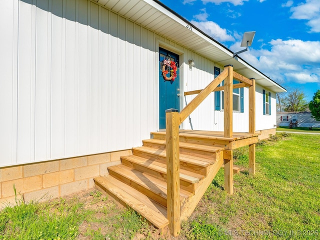 entrance to property with a lawn