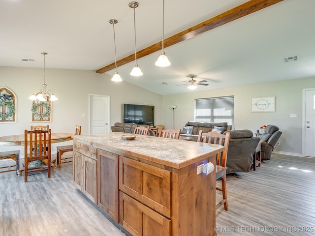 kitchen with visible vents, light wood-style flooring, lofted ceiling with beams, and ceiling fan with notable chandelier