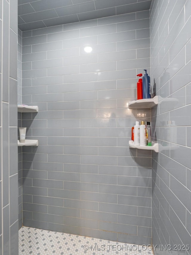 bathroom with a tile shower