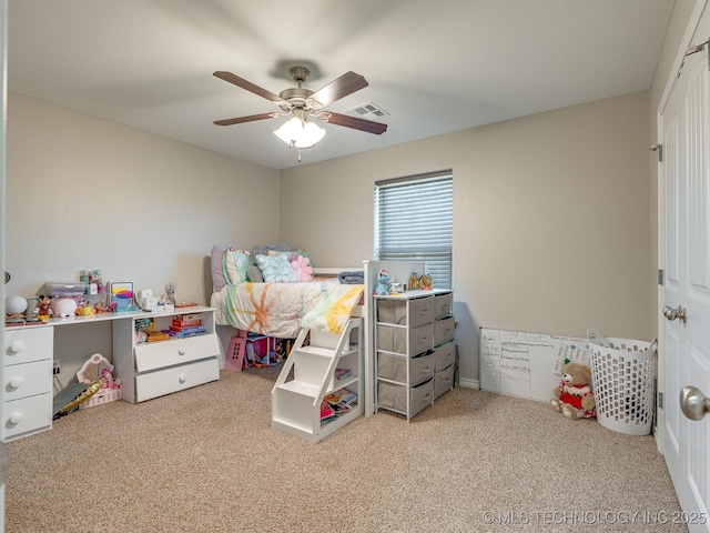 carpeted bedroom with a ceiling fan and visible vents