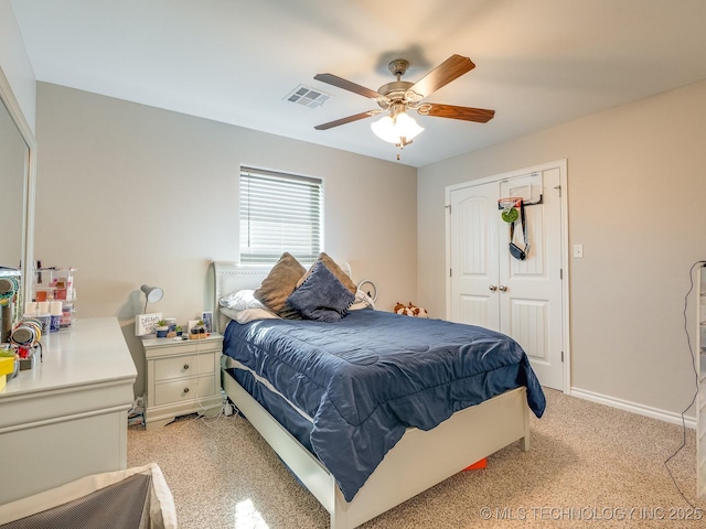 bedroom featuring visible vents, a closet, light colored carpet, and a ceiling fan
