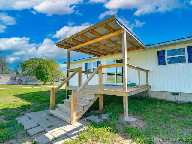 wooden terrace featuring a lawn