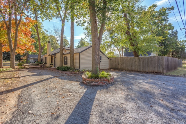 3004 E 49th St, Tulsa, OK 74105 - view of side of property with fence and a chimney