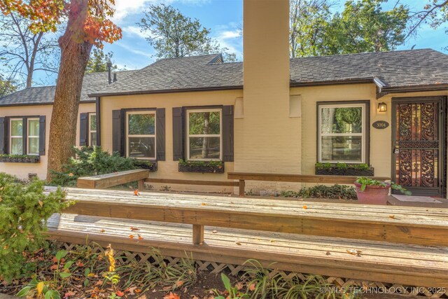 3004 E 49th St, Tulsa, OK 74105 - back of house with a shingled roof and stucco siding