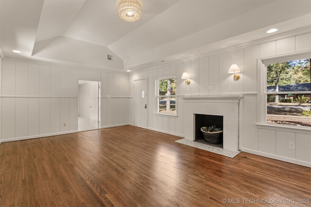 3004 E 49th St, Tulsa, OK 74105 - unfurnished living room with visible vents, a decorative wall, a fireplace, vaulted ceiling, and wood finished floors
