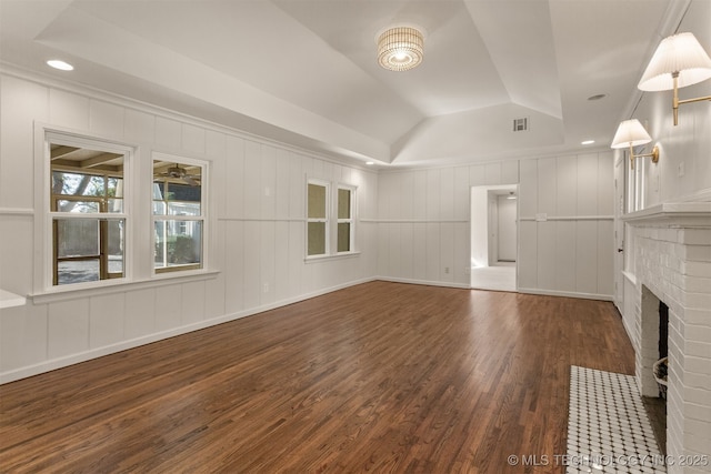 3004 E 49th St, Tulsa, OK 74105 - unfurnished living room with a decorative wall, a tray ceiling, wood finished floors, and a fireplace