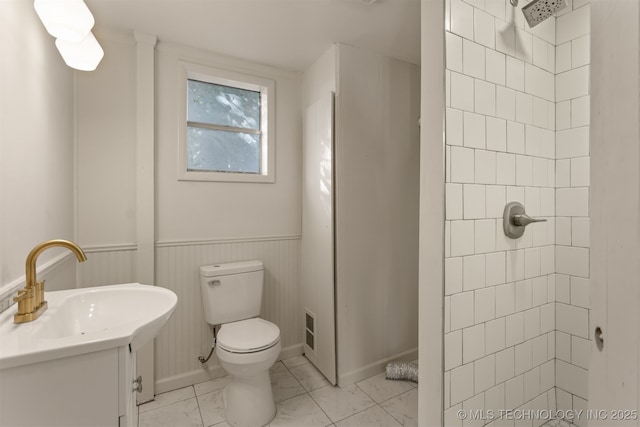 3004 E 49th St, Tulsa, OK 74105 - bathroom with toilet, vanity, baseboards, and a tile shower