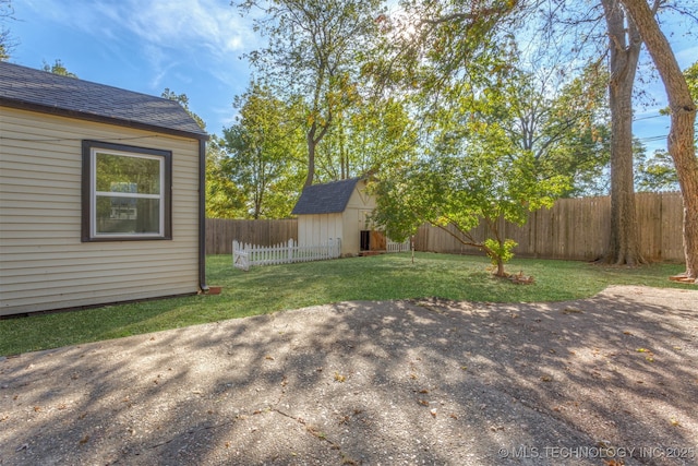 3004 E 49th St, Tulsa, OK 74105 - view of yard featuring an outbuilding, a fenced backyard, and a shed