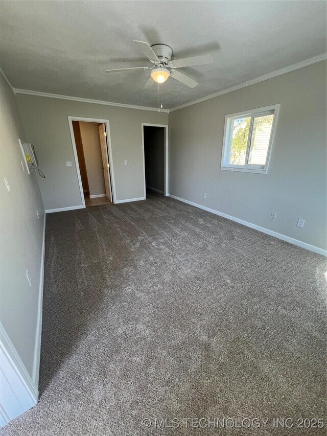 319 S Main St, Owasso, OK 74055 - unfurnished bedroom with crown molding, baseboards, a ceiling fan, and carpet