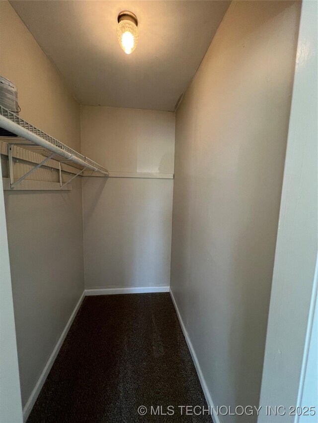 319 S Main St, Owasso, OK 74055 - spacious closet with dark carpet