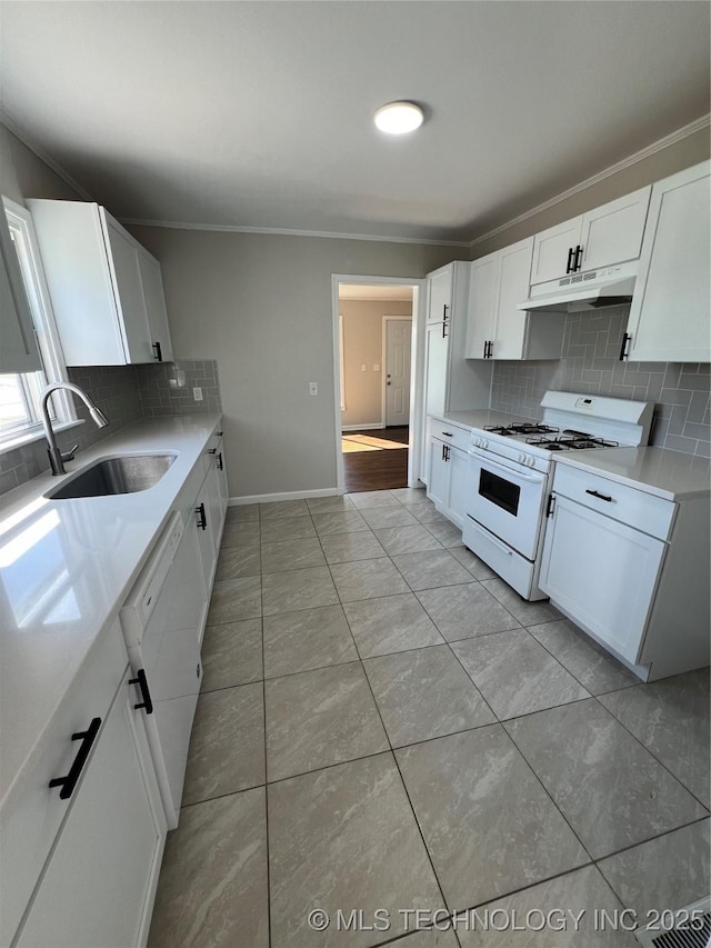 319 S Main St, Owasso, OK 74055 - kitchen featuring tasteful backsplash, white appliances, light countertops, under cabinet range hood, and a sink