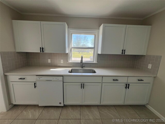 319 S Main St, Owasso, OK 74055 - kitchen featuring white cabinets, decorative backsplash, a sink, and white dishwasher