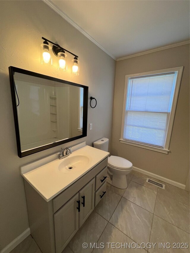 319 S Main St, Owasso, OK 74055 - bathroom with crown molding, vanity, visible vents, toilet, and baseboards