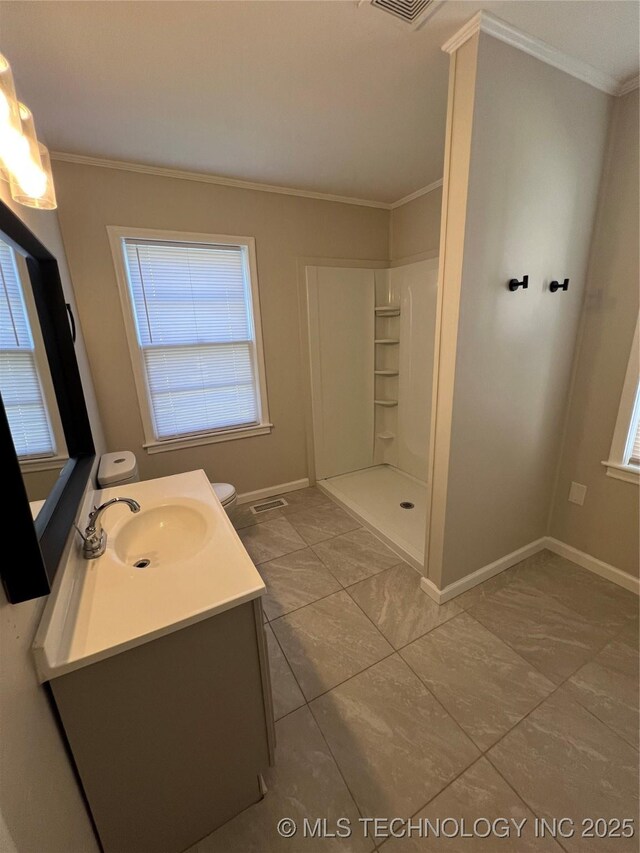 319 S Main St, Owasso, OK 74055 - full bath featuring a stall shower, a healthy amount of sunlight, vanity, and ornamental molding