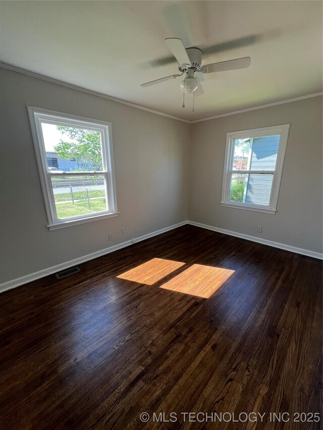 319 S Main St, Owasso, OK 74055 - spare room with crown molding, baseboards, and dark wood-type flooring