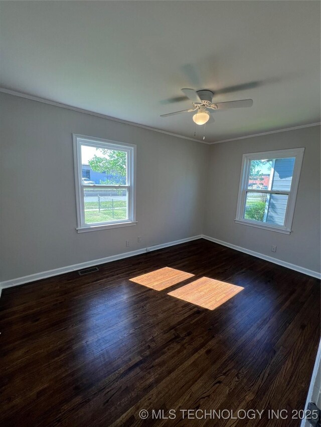 319 S Main St, Owasso, OK 74055 - empty room with dark wood-style floors, baseboards, and ornamental molding