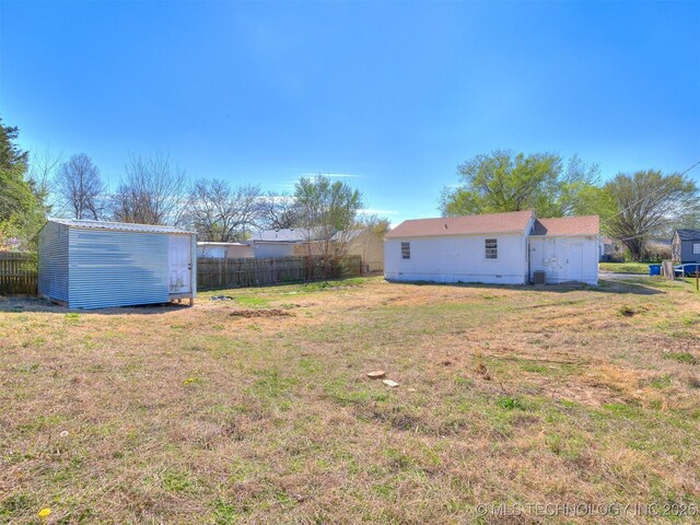 1809 N Delaware Pl, Tulsa, OK 74110 - view of yard with a storage shed, an outdoor structure, and fence