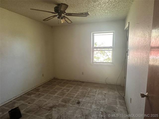empty room featuring a textured ceiling and a ceiling fan