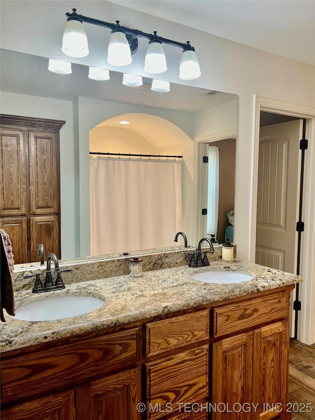 2516 Stage Coach Ave, Durant, OK 74701 - full bathroom with double vanity, visible vents, and a sink