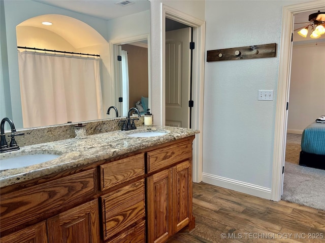 2516 Stage Coach Ave, Durant, OK 74701 - full bathroom with baseboards, wood finished floors, a sink, and visible vents