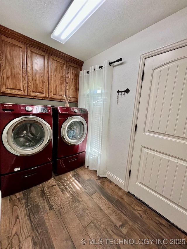 2516 Stage Coach Ave, Durant, OK 74701 - clothes washing area with separate washer and dryer, baseboards, wood finished floors, and cabinet space