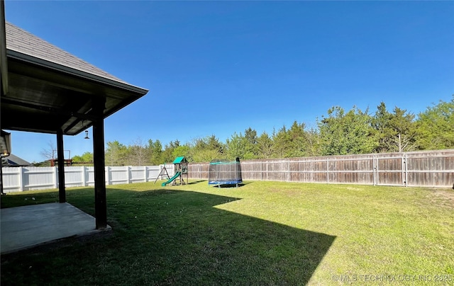 2516 Stage Coach Ave, Durant, OK 74701 - view of yard featuring a fenced backyard, a playground, a trampoline, and a patio