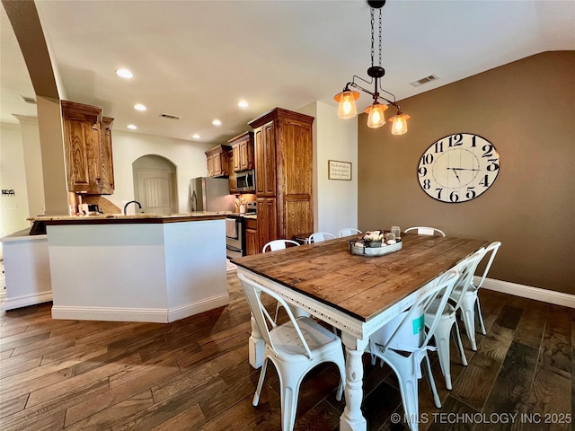 2516 Stage Coach Ave, Durant, OK 74701 - dining area featuring recessed lighting, arched walkways, visible vents, and dark wood finished floors