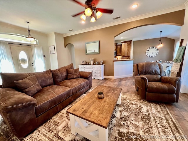2516 Stage Coach Ave, Durant, OK 74701 - living area with light wood-type flooring, ornamental molding, visible vents, ceiling fan, and arched walkways