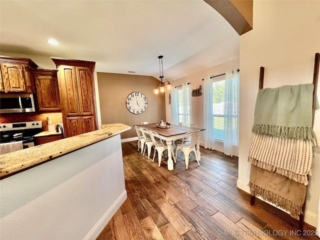 2516 Stage Coach Ave, Durant, OK 74701 - kitchen with baseboards, dark wood finished floors, light stone countertops, decorative backsplash, and stainless steel appliances