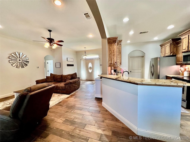 2516 Stage Coach Ave, Durant, OK 74701 - kitchen featuring open floor plan, arched walkways, and visible vents
