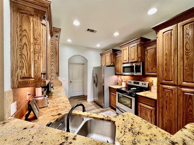 2516 Stage Coach Ave, Durant, OK 74701 - kitchen featuring tasteful backsplash, appliances with stainless steel finishes, light stone countertops, and recessed lighting
