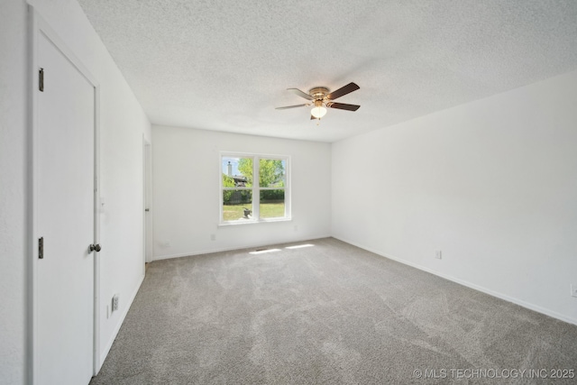 10785 E Dogwood Ct, Claremore, OK 74019 - unfurnished bedroom with baseboards, a ceiling fan, carpet flooring, and a textured ceiling